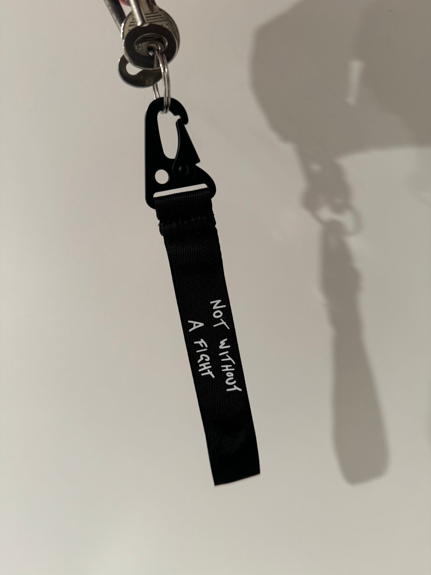 Daniel Ricciardo “Not without a fight” inspired wristlet keychain.